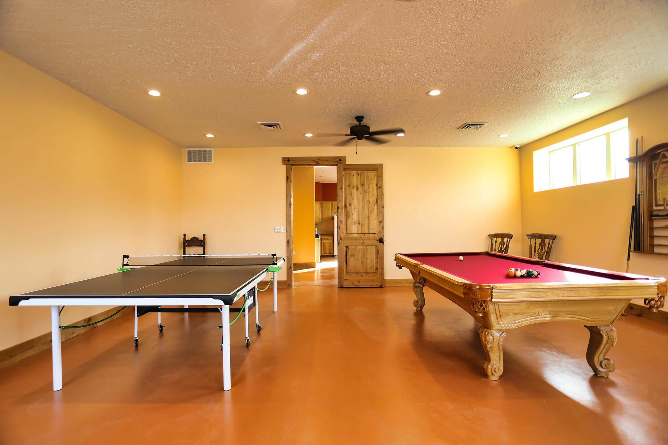 Game room with billiards table and ping pong at Sundowner Park clubhouse